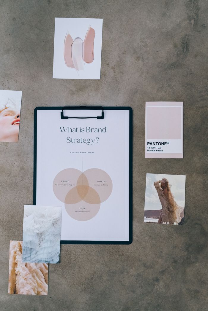 gallery-1 Flat-lay view of a brand strategy board, encircled by mood samples and color swatches on concrete.